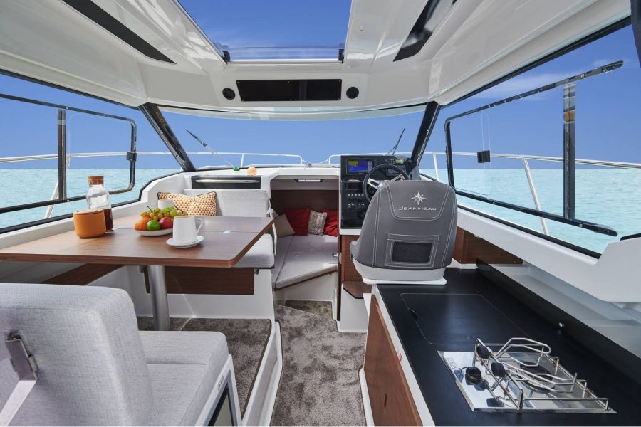 Jeanneau Merry Fisher 795 - wheelhouse interior with table on port side and galley on starboard side