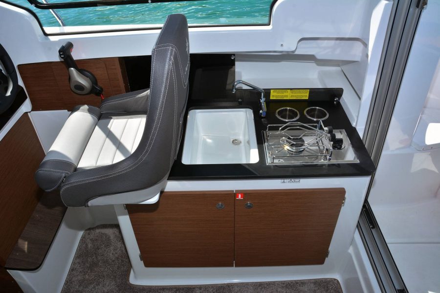 Jeanneau Merry Fisher 695 - starboard side helm seat and luxury galley