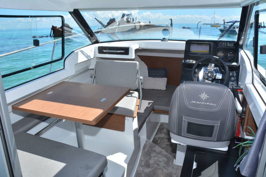 Jeanneau Merry Fisher 695 - wheelhouse with port side saloon table and starboard side galley