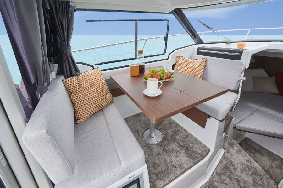 Jeanneau Merry Fisher 795 Legend - port side table and seating in wheelhouse